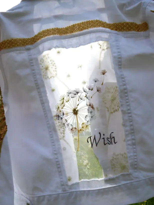 White denim jacket with dandelion embroidery and the word Wish